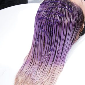 Purple Toning haircare woman with shampoo in salon sink