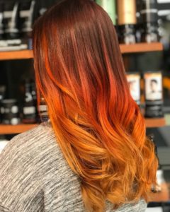 fall hair trends- vivid red and yellow balayage on long hair