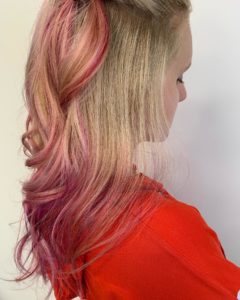 Hair Color Guide in your 20s girl with blonde hair and pink balayage hair color