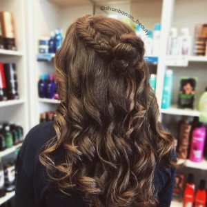 Half updo with braid into bun with curls for prom from Hair Cuttery